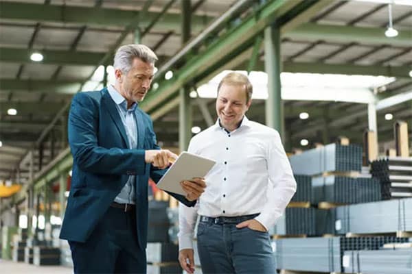 Two men in a warehouse looking at a tablet to help illustrate Single Pain of Glass.