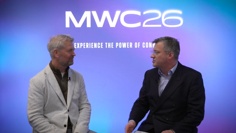 Image of Matthew Coleman and Jim Morrish talking with each other and a MWC26 banner behind them.