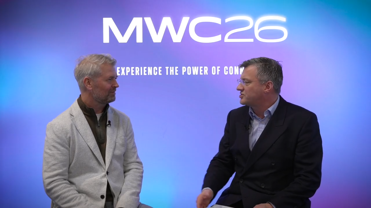 Image of Matthew Coleman and Jim Morrish talking with each other and a MWC26 banner behind them.