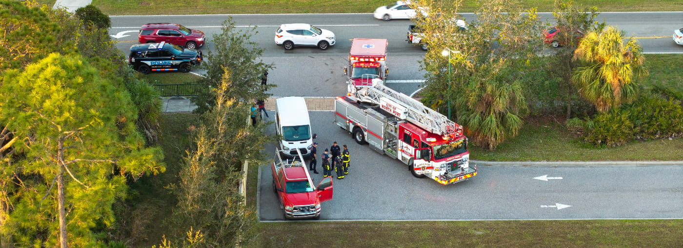 Car crash with first responders, including police, paramedics, and firefighters helping at accident site all needing IoT connectivity and device management for first responders